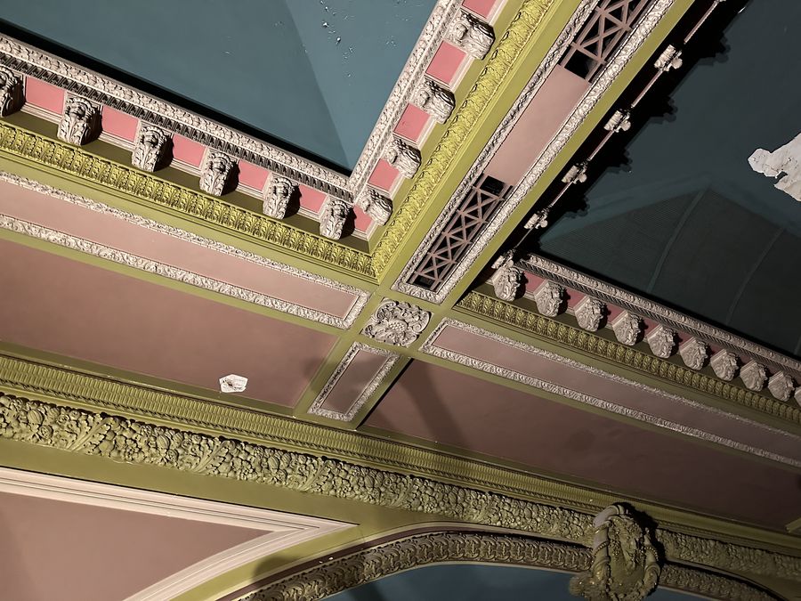 Original 1916 ornamental plasterwork on an upper-floor ceiling, photographed during a walkthrough before the restoration. May 20, 2024.